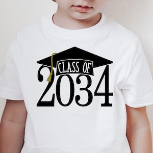 May include: White t-shirt with a black graduation cap and the text "Class of 2034" printed on the front.