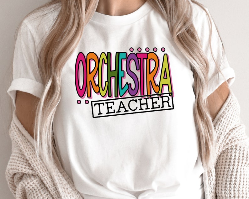 May include: White t-shirt with the text "ORCHESTRA TEACHER" in colorful letters.