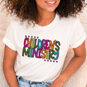 May include: White t-shirt with a colorful graphic that says "CHILDREN'S MINISTRY".