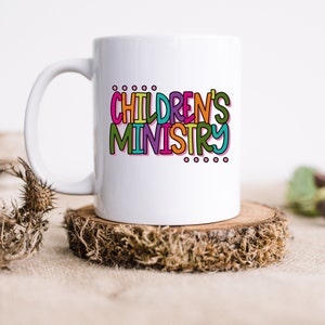 May include: White ceramic mug with a colorful graphic that says "CHILDREN'S MINISTRY".