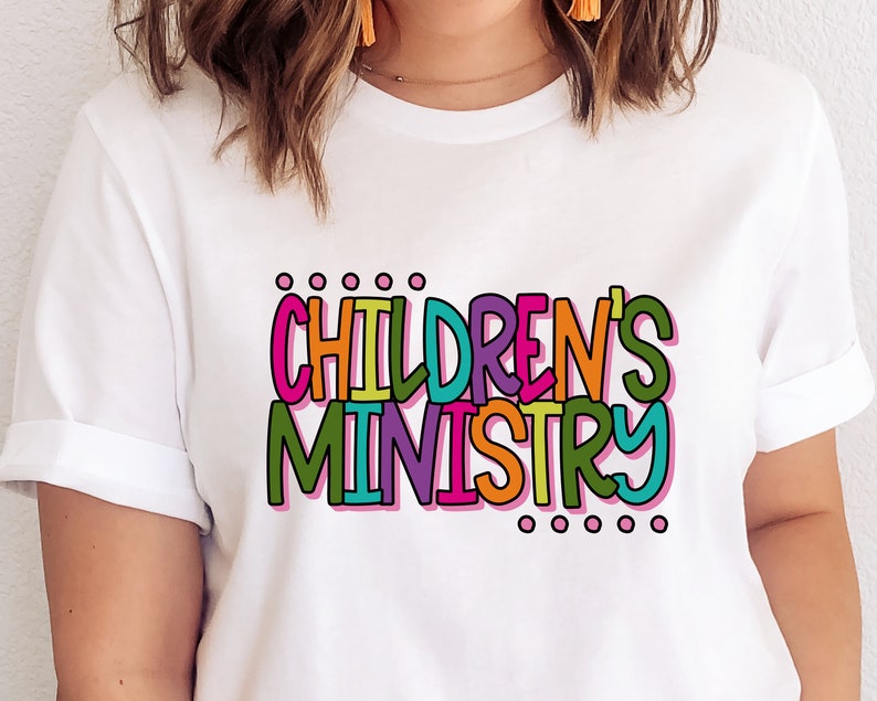 May include: White t-shirt with the text "CHILDREN'S MINISTRY" in colorful, outlined letters.