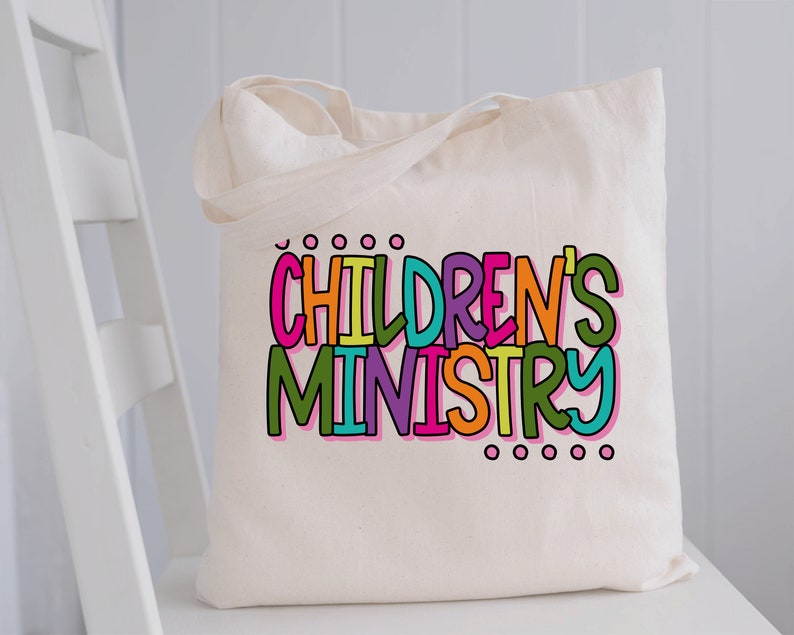 May include: A white canvas tote bag with the words "CHILDREN'S MINISTRY" printed in colorful letters.