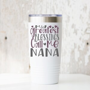 May include: White stainless steel tumbler with a purple design that says "My greatest blessings call me Nana".