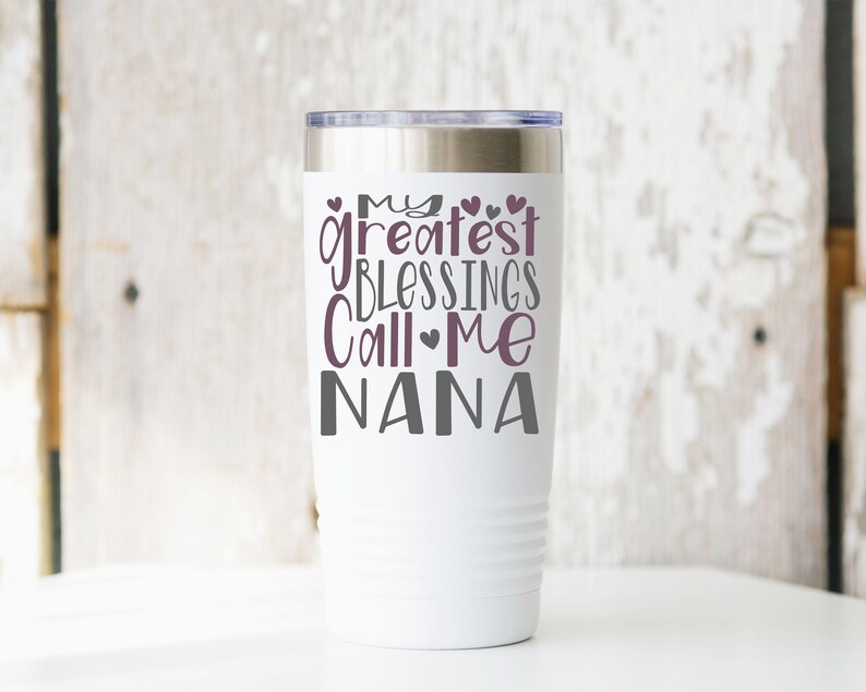 May include: White stainless steel tumbler with a purple design that says "My greatest blessings call me Nana".