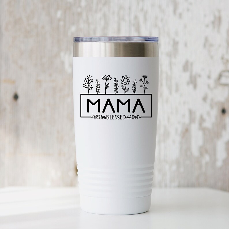 May include: White stainless steel tumbler with a black design of flowers and the text "MAMA BLESSED".