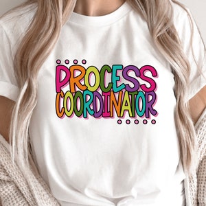 May include: White t-shirt with the text "PROCESS COORDINATOR" in colorful, outlined letters.