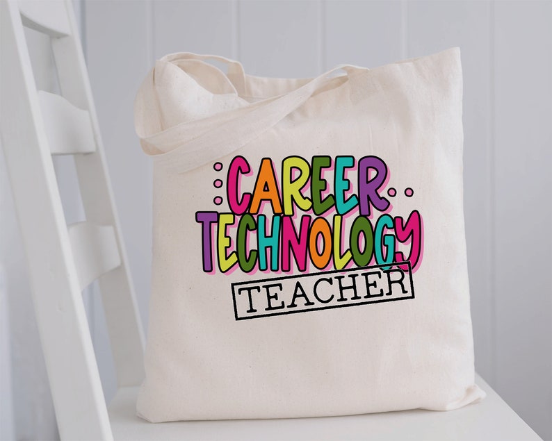 May include: A white canvas tote bag with the text "Career Technology Teacher" in colorful, outlined letters. The text is in a playful, handwritten font.
