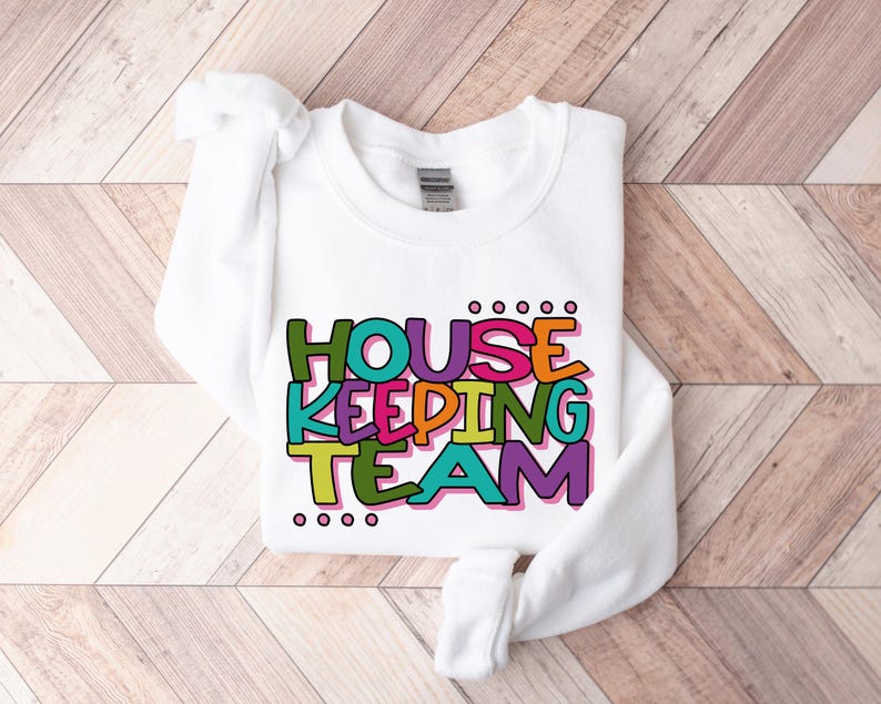 May include: White sweatshirt with the text "HOUSE KEEPING TEAM" in colourful letters.