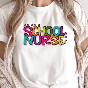 May include: White t-shirt with the text "SCHOOL NURSE:" in colorful letters. The letters are outlined in black and have a 3D effect.