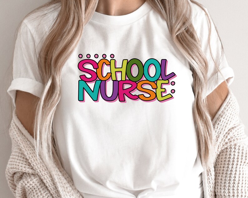May include: White t-shirt with the text "SCHOOL NURSE:" in colorful letters. The letters are outlined in black and have a 3D effect.