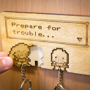 Team Rocket Laser-Cut Key Holder – “Prepare for Trouble” Wall Mount with Jessie & James Pixelated Keyrings