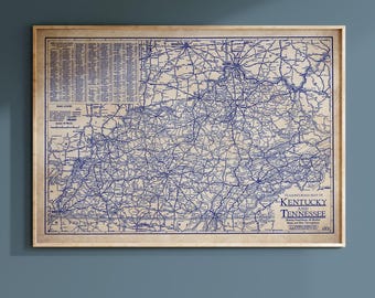 May include: A framed vintage road map of Kentucky and Tennessee, featuring a detailed blue and white design. The map includes road networks, cities, and geographical features, with text in the upper left corner and the title "Classic Road Map of Kentucky and Tennessee" in the lower right.
