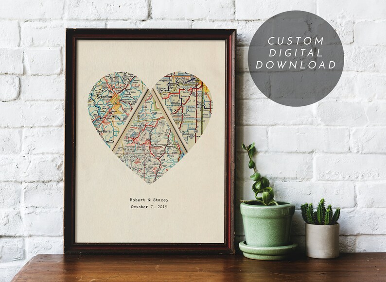 May include: Framed artwork featuring a heart-shaped map composed of four sections. The map is in shades of beige, red, and blue. The names "Robert & Stacey" and the date "October 7, 2019" are printed below the heart. The text "CUSTOM DIGITAL DOWNLOAD" is in a gray circle.