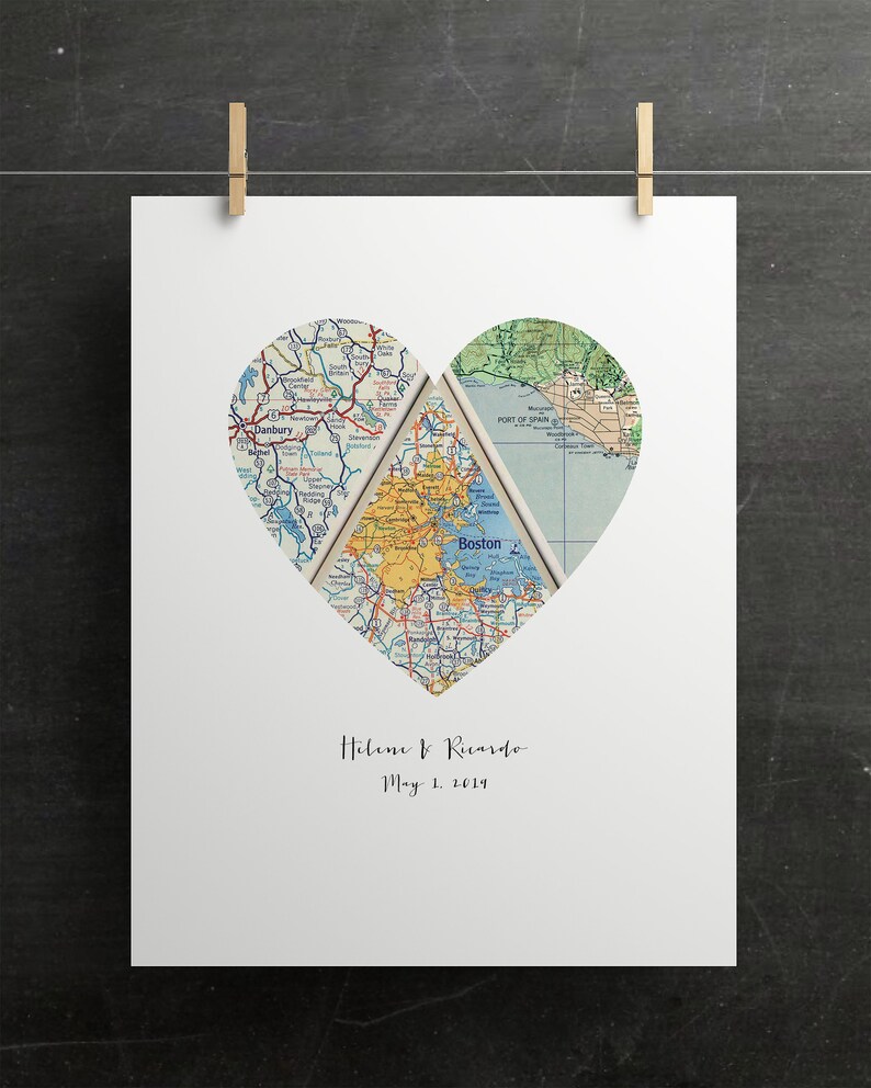 May include: A white print featuring a heart-shaped cutout revealing vintage map sections. The maps are in shades of blue, green, and yellow. The names "Helene & Ricardo" and the date "May 1, 2014" are printed below the heart.
