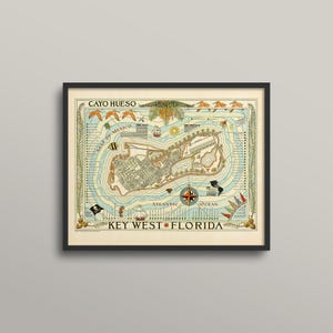 May include: Framed vintage map of Key West, Florida, with the text "CAYO HUESO" at the top and "KEY WEST FLORIDA" at the bottom. The map features a compass rose, illustrations of marine life, and a detailed depiction of the island.