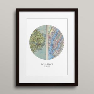 May include: Framed print featuring a circular map design. The map is split, with one side showing a green and yellow map and the other a blue and white map. The names "Mary & Edward" and the date "09.19.25" are printed below the map.