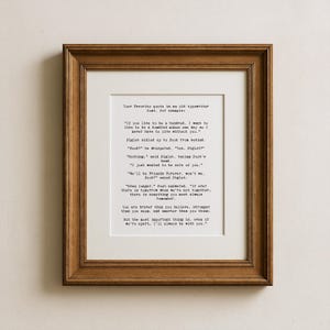 May include: A framed print with a brown wooden frame. The print features a quote in an old typewriter font. The quote is about friendship and love. The text is in black on a white background.