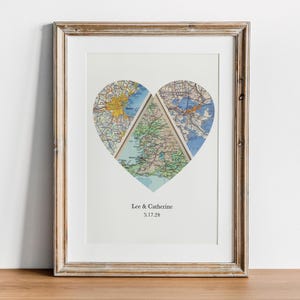 A framed print depicting a heart-shaped collage of three different maps, with the names 'Lee & Catherine' and the date '3.7.24' printed below.