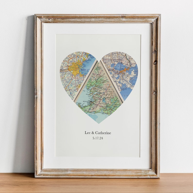 A framed print depicting a heart-shaped collage of three different maps, with the names 'Lee & Catherine' and the date '3.7.24' printed below.