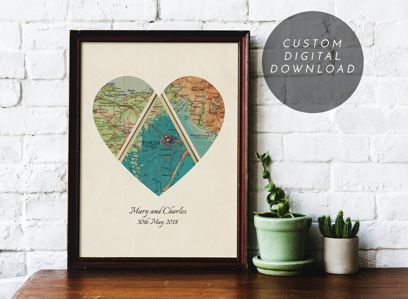 May include: Framed heart-shaped map art print. The heart is composed of three map sections, with a blue section in the center. The print includes the names "Mary and Charles" and the date "30th May 2018". A gray circle with text reads "CUSTOM DIGITAL DOWNLOAD".