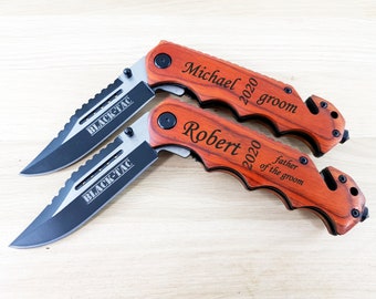 May include: Two personalized pocket knives with wooden handles. The top knife is engraved with "Michael 2020 groom" and the bottom knife is engraved with "Robert 2020 father of the groom".