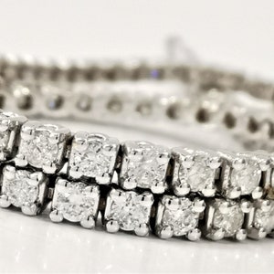 May include: A double row diamond tennis bracelet with a white gold setting. The bracelet is made of small, square-shaped diamonds.