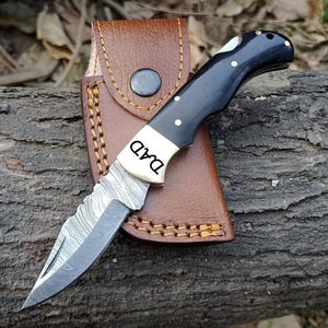 Damascus Folding Pocket Knife: Bull Horn Handle, Leather Sheath