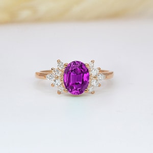 Pink sapphire high engagement ring | Pink sapphire and diamond featuring cluster ring | Oval sapphire and marquise diamond bespoke ring