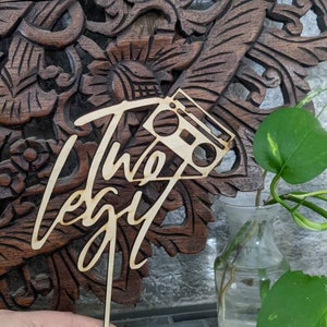 May include: Wooden cake topper with the words "The Legit" written in cursive and a silhouette of a boombox.