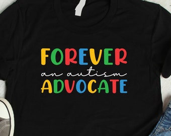May include: A black short-sleeved t-shirt featuring the multicolored text FOREVER an autism ADVOCATE. The shirt is displayed alongside gray canvas sneakers and blue denim jeans, with a small sidebar showing icons for other available garment styles.