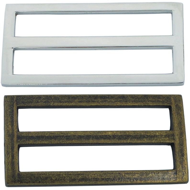 May include: Two metal belt buckle slides, one silver and one antique gold. Both have a double-slot design.