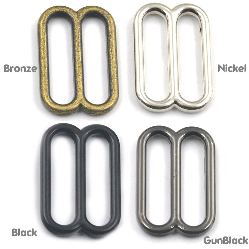 May include: Four metal slider buckles in different finishes: bronze, nickel, black, and gunmetal. Each buckle has two oval loops.