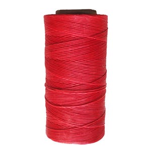 May include: A spool of red waxed thread for leather crafting.