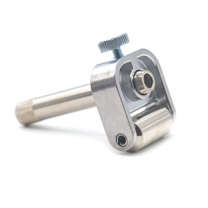 May include: A silver metal tool with a roller and a knob. The tool is used for shaping and smoothing edges.