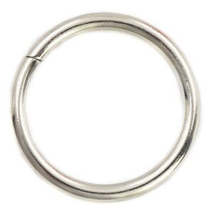 May include: A silver metal ring, also known as a key ring or jump ring, is a simple, circular shape with a smooth, polished finish.