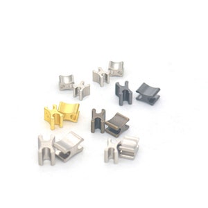 May include: Assortment of metal clasps in silver, gold, and black finishes. The clasps are shaped like an 'H' and have a curved design.