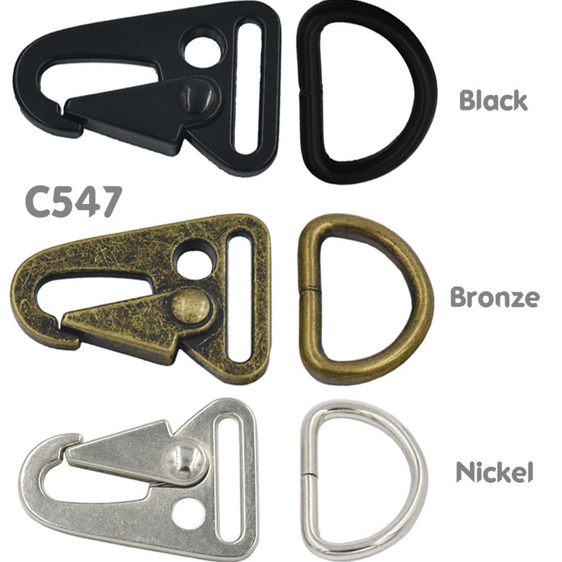 May include: Three sets of metal clasps and D-rings in black, bronze, and nickel finishes. The clasps are triangular shaped with a spring-loaded gate. The D-rings are circular. C547 is printed on the image.