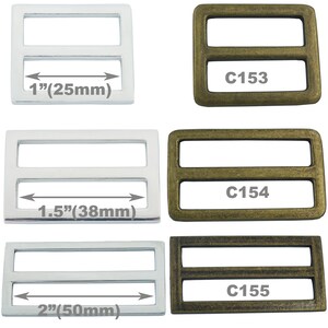 May include: Three silver and gold metal slider buckles with two bars. The buckles are 1 inch, 1.5 inches, and 2 inches wide. The buckles are labeled C153, C154, and C155.