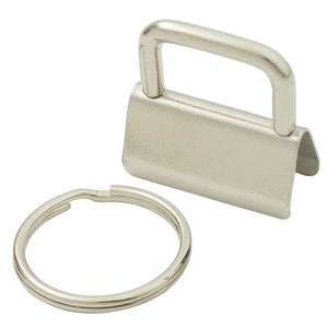 May include: Silver key ring with a metal loop and a rectangular metal clasp.