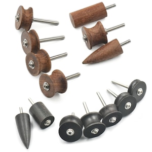 May include: A set of 12 leather working tools with wooden and rubber handles. The tools have different shapes and sizes, including round, oval, and pointed.
