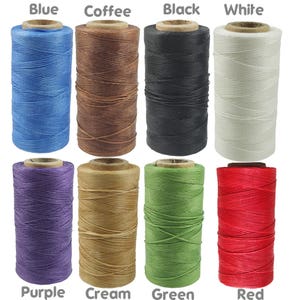 May include: Assortment of 10 spools of waxed thread in various colours, including blue, coffee, black, white, purple, cream, green, and red. The thread is wound around spools with paper labels.