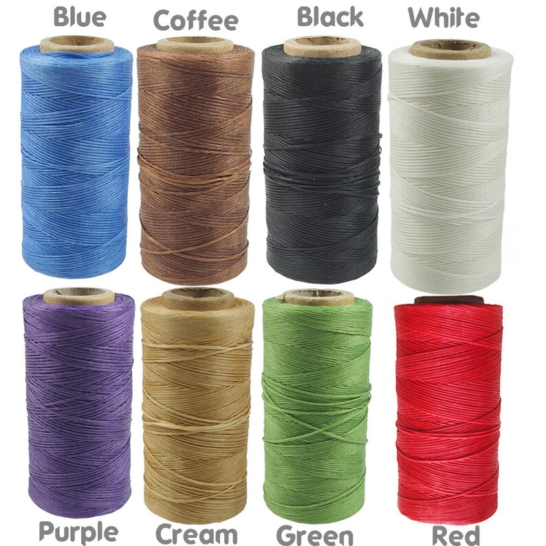 May include: Assortment of 10 spools of waxed thread in various colours, including blue, coffee, black, white, purple, cream, green, and red. The thread is wound around spools with paper labels.