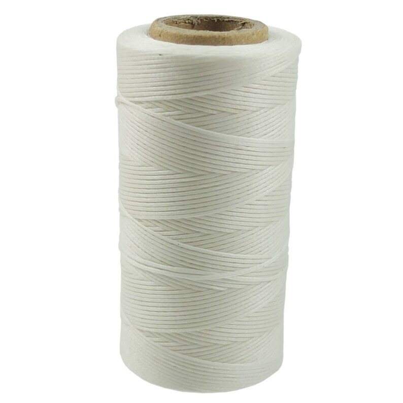 May include: A spool of white waxed thread for leather crafting. The thread is wound tightly on a cardboard spool.
