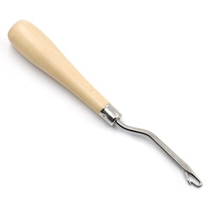 May include: A wooden handled crochet hook with a metal hook. The hook is bent at a 90-degree angle.