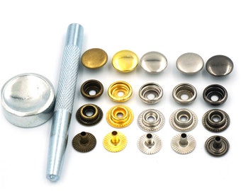 May include: A set of metal snap fasteners in various finishes, including gold, silver, and bronze. The set also includes a tool for attaching the snaps.