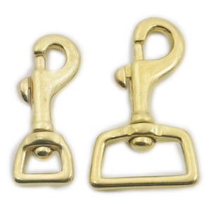 May include: Two brass swivel snap hooks. The larger hook has a rectangular loop and the smaller hook has a round loop.