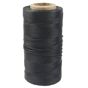 May include: A spool of black waxed thread for leather crafting.