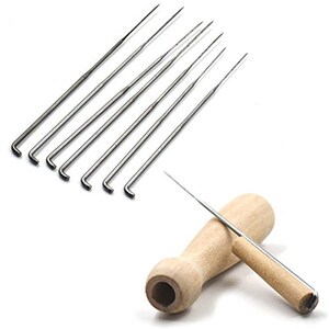 May include: A set of eight metal felting needles with a bent tip, and a wooden felting tool with a needle.