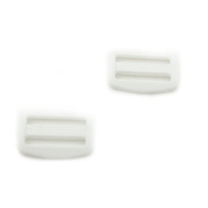 May include: Two white plastic slider buckles. The buckles have two slots for a strap or ribbon.