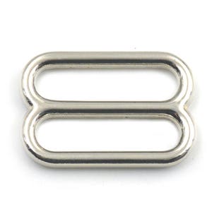 May include: Silver metal slider buckle with two oval loops.